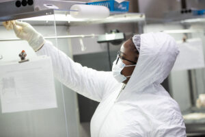 woman in biosafety gear in the lab